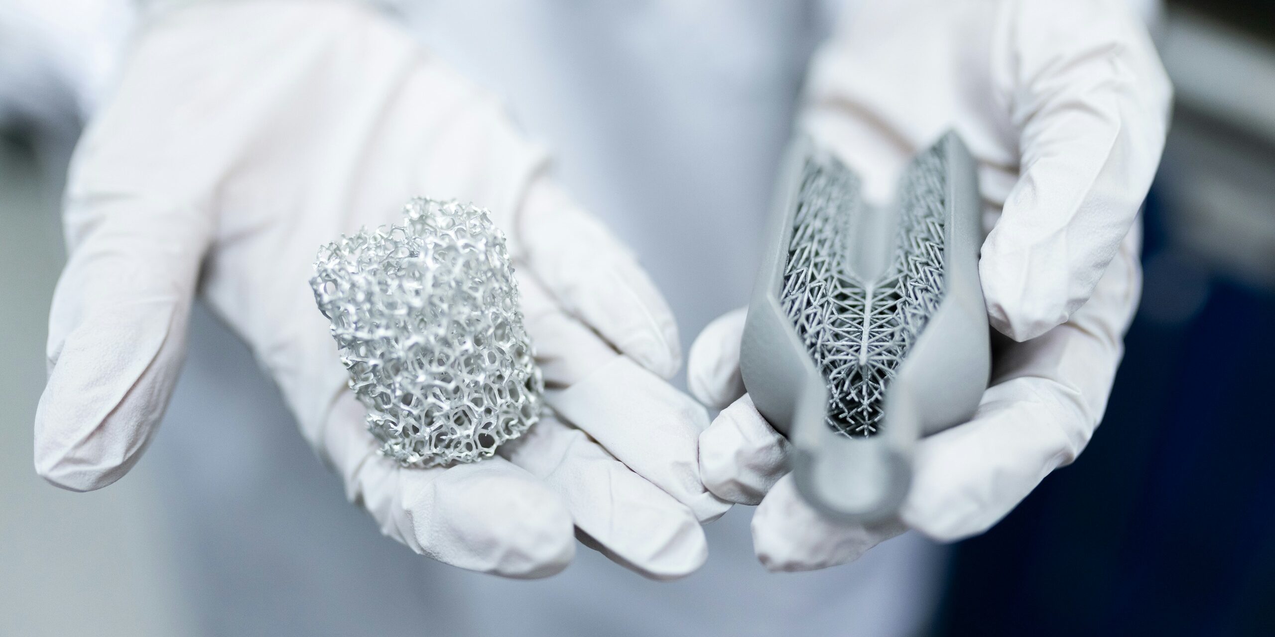 thisisengineering-TTmuplyNMHU-unsplash (1) Image of a white gloved hands holding two engineered objects